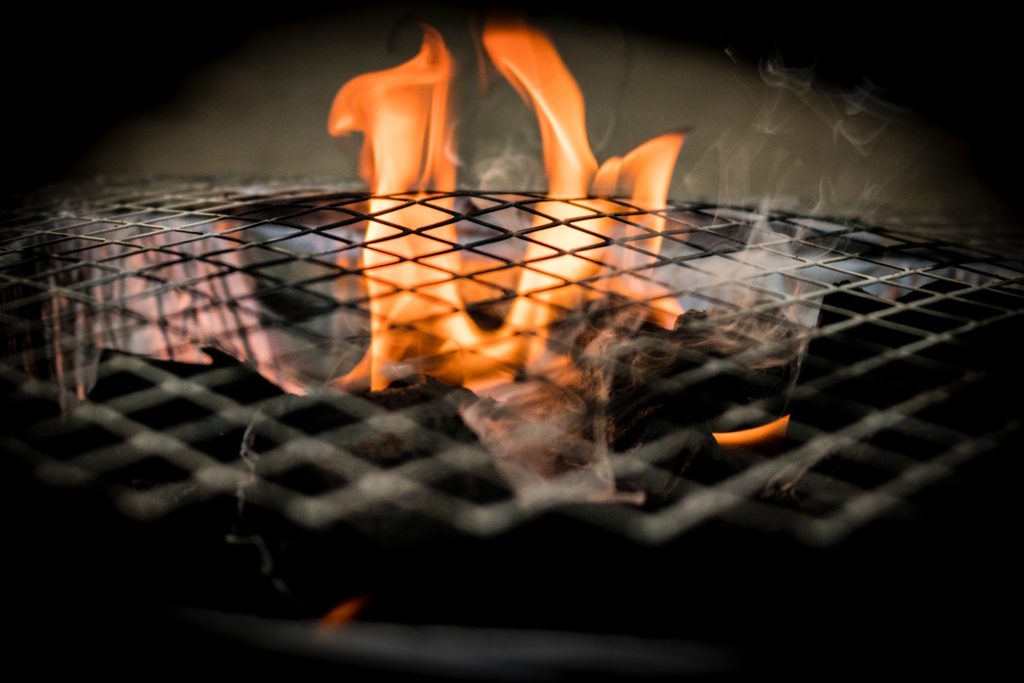 Grill flames touching the grates